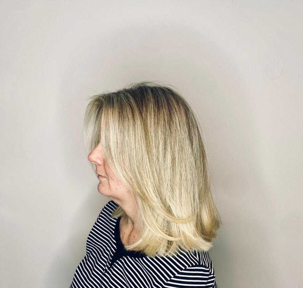 Creamy blonde lob with dimensional highlights, side profile